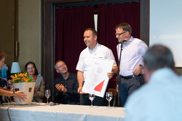 Anton Gjergjaj erhält die Urkunde vom Regierungsrat Kaspar Sutter.